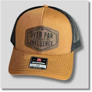 Caramel Over Par Under the Influence golf hat featuring a dark decorative patch with humorous golf-themed lettering