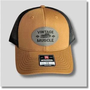 Caramel and black trucker hat featuring a vintage muscle car graphic on a decorative leather patch