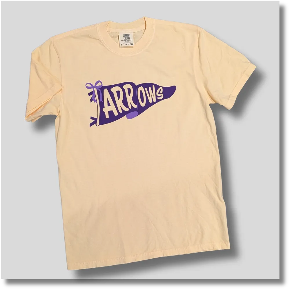 Light yellow Watertown Arrows graphic T-shirt featuring a purple and gold school spirit pennant design